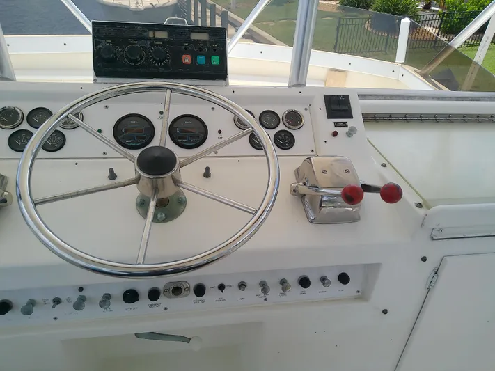 Fishin Post Yacht Photos Pics 1990 Post 44 Sport Fisherman helm with steering wheel and control panel.