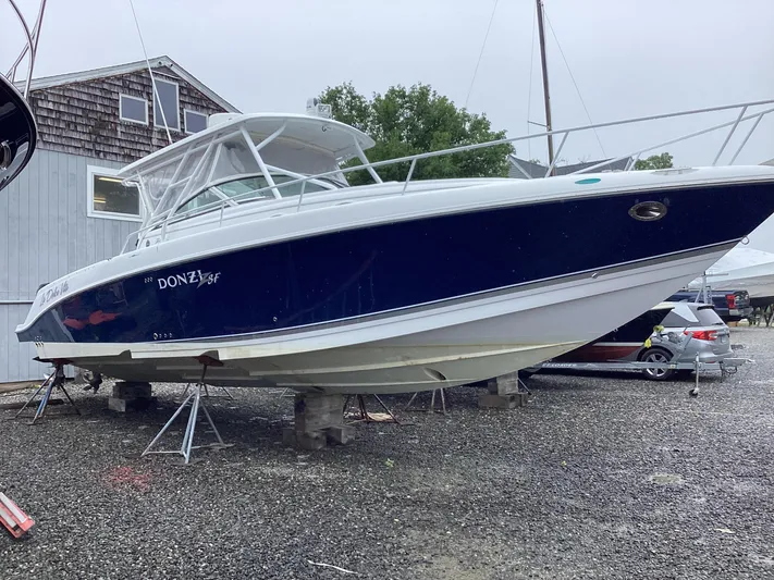  Yacht Photos Pics 2008 Donzi 38 ZSF boat on stands in a gravel yard.