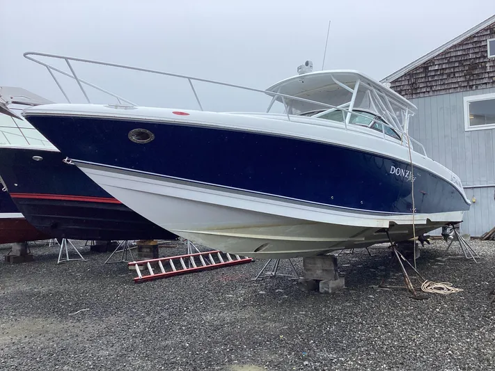  Yacht Photos Pics 2008 Donzi 38 ZSF boat on dry dock, blue and white hull, overcast day.