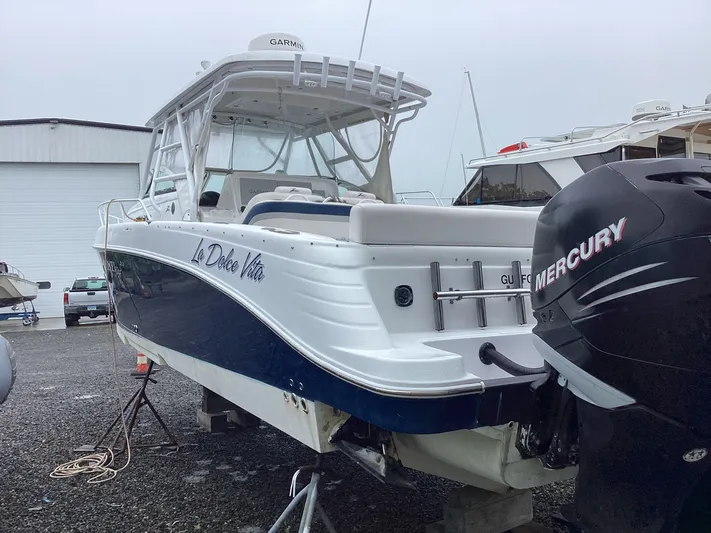  Yacht Photos Pics 2008 Donzi 38 ZSF boat with Mercury engine, docked on gravel.