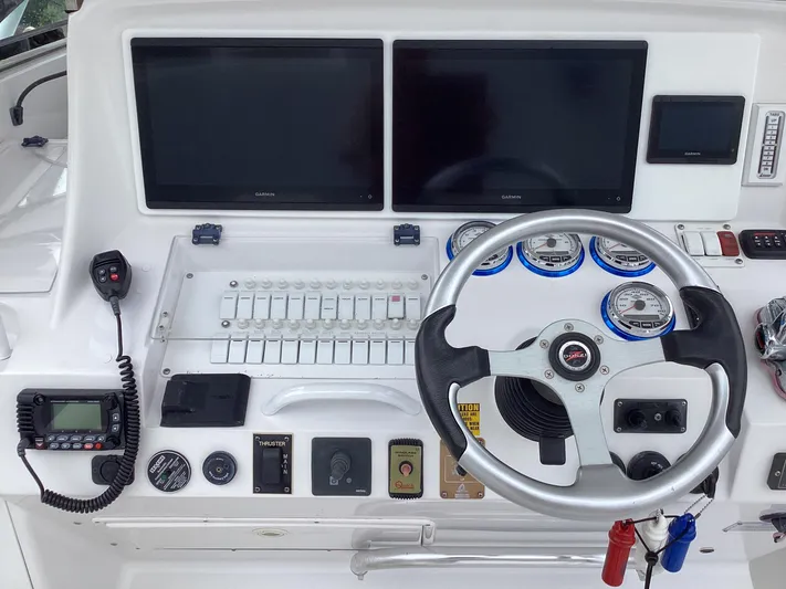  Yacht Photos Pics Control panel of a 2008 Donzi 38 ZSF boat with steering wheel and gauges.