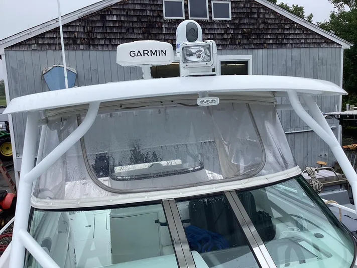  Yacht Photos Pics 2008 Donzi 38 ZSF boat with Garmin radar, docked near a wooden building.