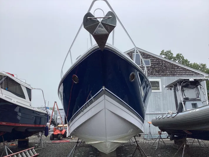  Yacht Photos Pics 2008 Donzi 38 ZSF boat on dry dock, surrounded by other vessels.