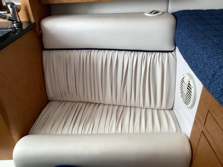  Yacht Photos Pics Interior seating of 2008 Donzi 38 ZSF boat with white upholstery and wood accents.