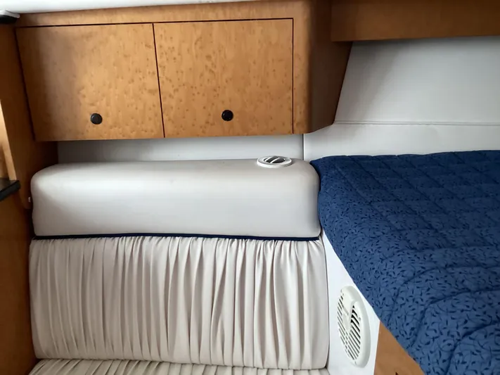  Yacht Photos Pics Interior of 2008 Donzi 38 ZSF boat with wood cabinets and blue bedding.