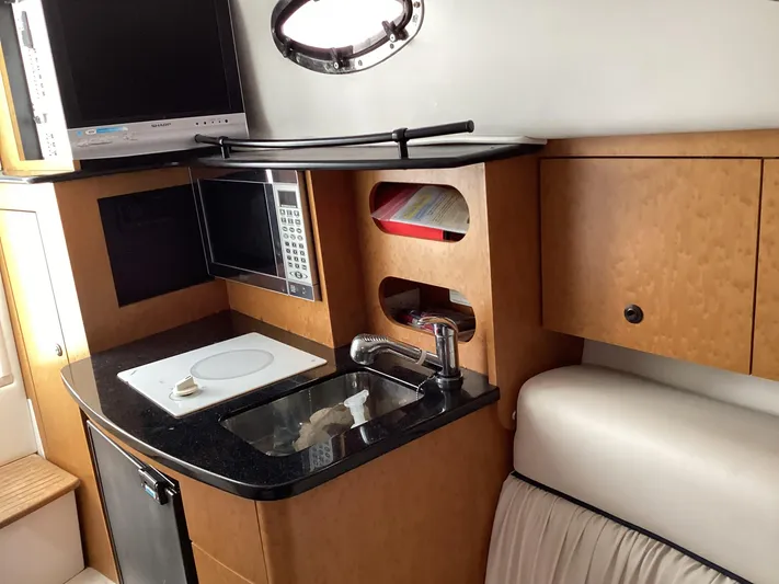  Yacht Photos Pics 2008 Donzi 38 ZSF boat interior with kitchenette, microwave, and sink.