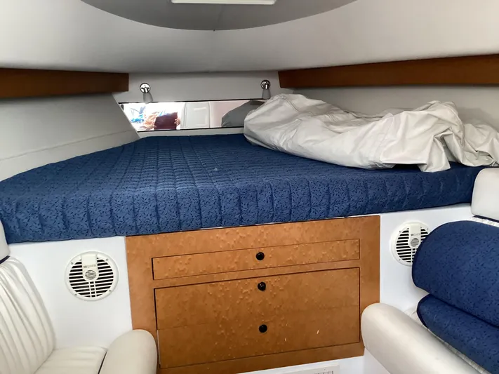  Yacht Photos Pics Interior cabin of 2008 Donzi 38 ZSF with blue bedding and wood accents.