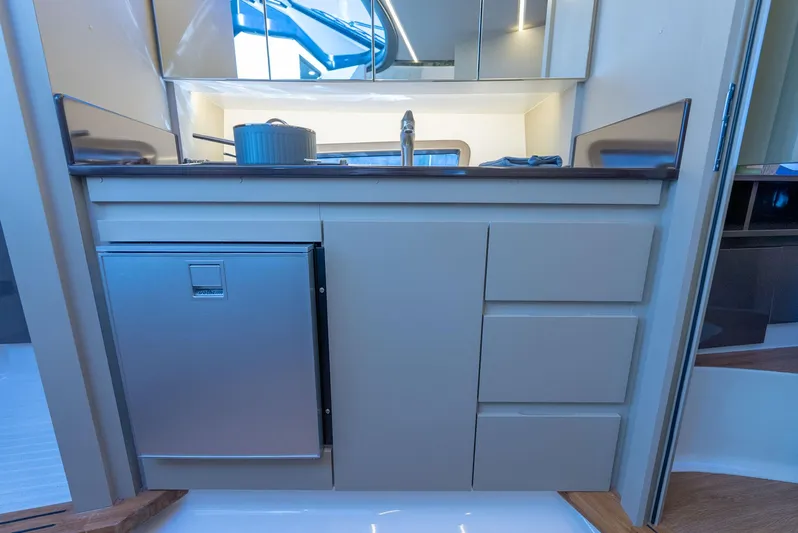 Music Yacht Photos Pics Modern kitchen area in a 2024 Hanover 415 yacht, featuring sleek cabinetry and stainless steel appliances.
