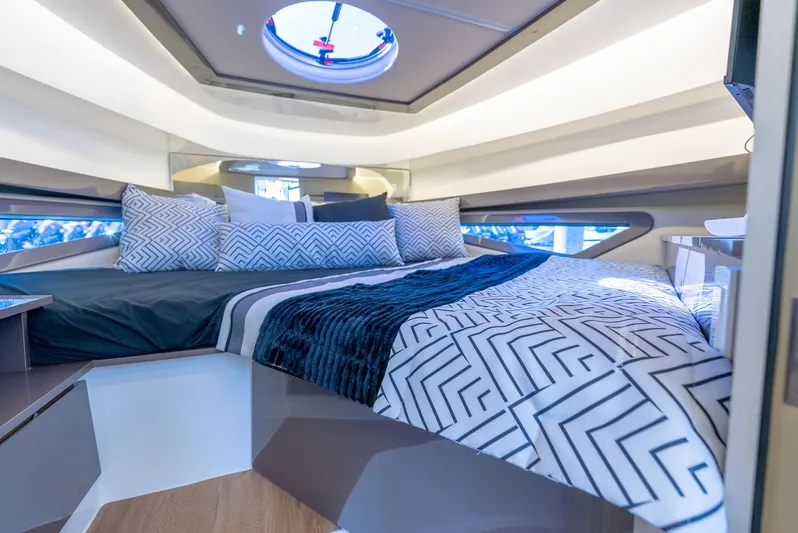 Music Yacht Photos Pics Luxurious interior of 2024 Hanover 415 yacht with modern bedding and skylight.