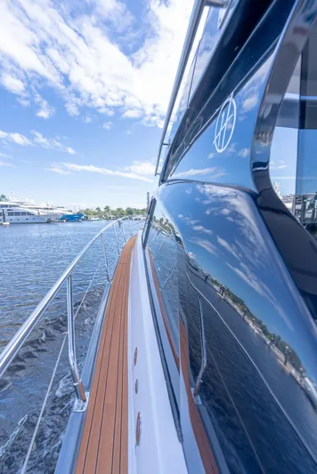 Music Yacht Photos Pics 2024 Hanover 415 yacht reflecting sky and water, showcasing sleek design and craftsmanship.