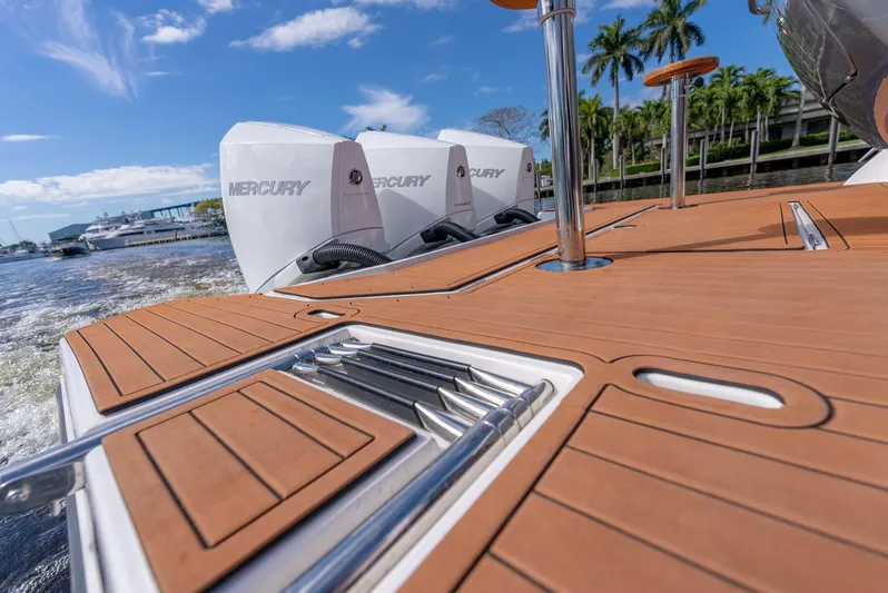 Music Yacht Photos Pics 2024 Hanover 415 boat deck with Mercury engines, featuring sleek wood finish and stainless steel accents.