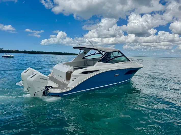  Yacht Photos Pics 2025 Sea Ray Sundancer 320 Outboard on calm waters.