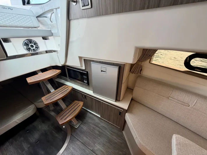  Yacht Photos Pics Interior of 2025 Sea Ray Sundancer 320 Outboard with stairs and seating area.