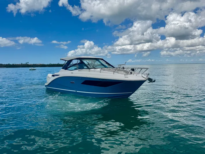  Yacht Photos Pics 2025 Sea Ray Sundancer 320 Outboard on calm waters.