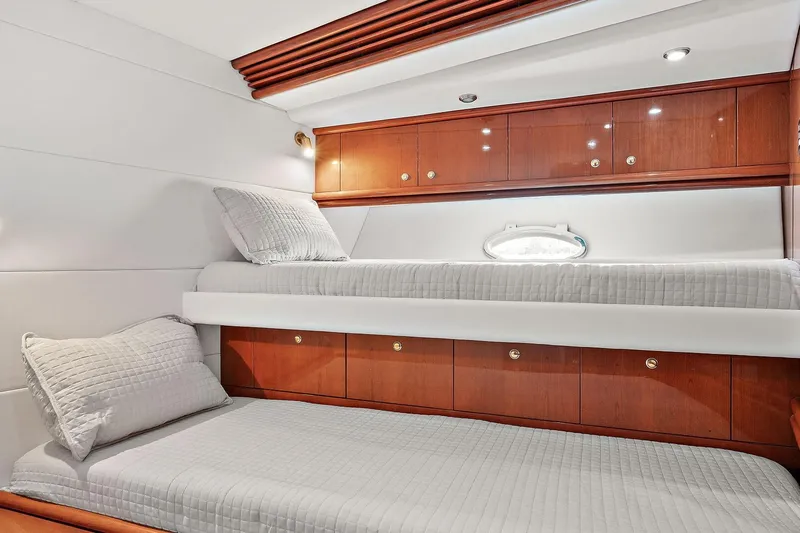 Blue Steel Yacht Photos Pics Luxurious cabin interior of 1998 Sunseeker Predator 80 yacht with wooden cabinetry and twin beds.