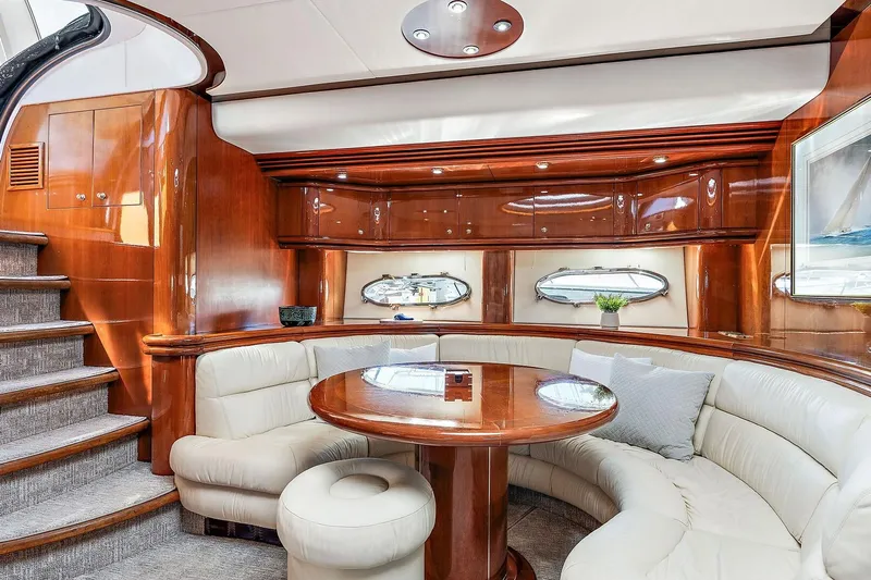 Blue Steel Yacht Photos Pics Luxurious interior of 1998 Sunseeker Predator 80 yacht with elegant wood finishes and plush seating.