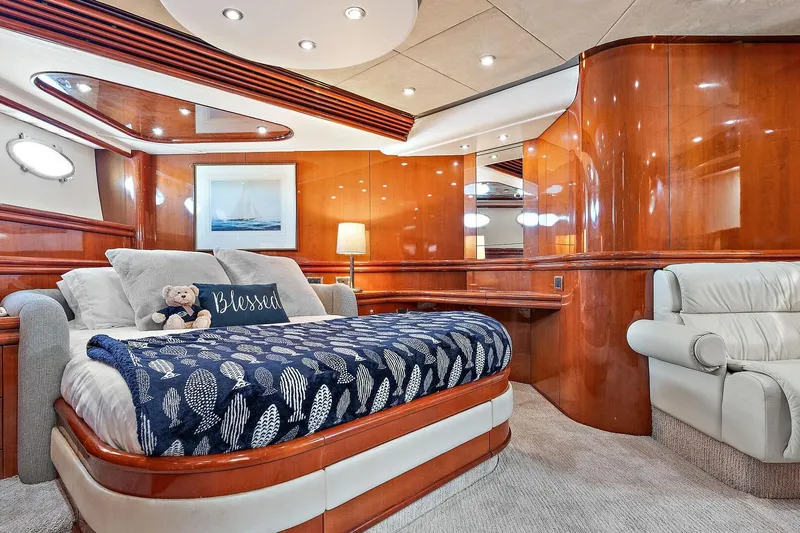 Blue Steel Yacht Photos Pics Luxurious Sunseeker Predator 80 yacht bedroom with elegant wood paneling and cozy bedding, 1998 model.