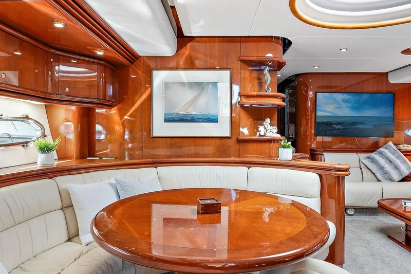Blue Steel Yacht Photos Pics Luxurious interior of 1998 Sunseeker Predator 80 yacht with elegant wood finishes and plush seating.