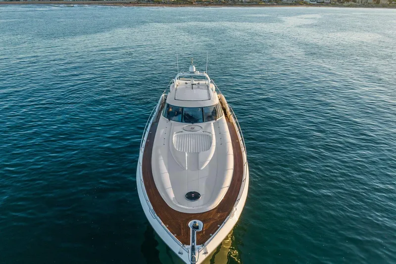 Blue Steel Yacht Photos Pics Sunseeker Predator 80 yacht from 1998 on calm blue waters, aerial view.