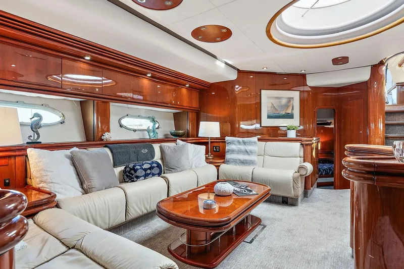 Blue Steel Yacht Photos Pics Luxurious interior of 1998 Sunseeker Predator 80 yacht with elegant wood finishes and plush seating.