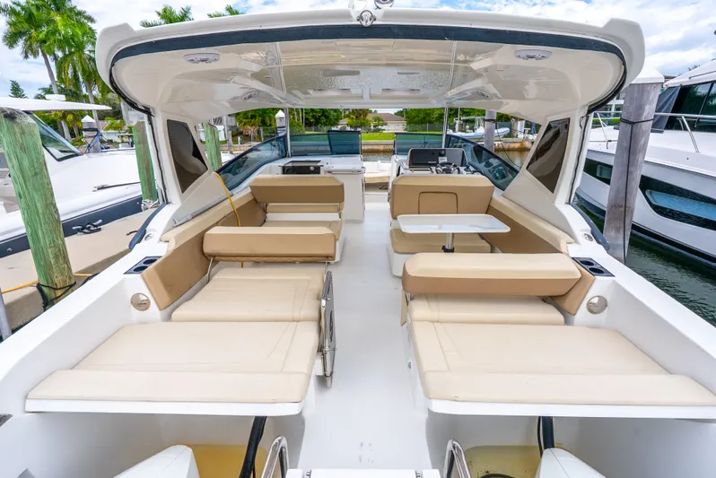 Ohana Yacht Photos Pics 2020 Aquila 32 yacht interior with beige seating and table, docked at marina.