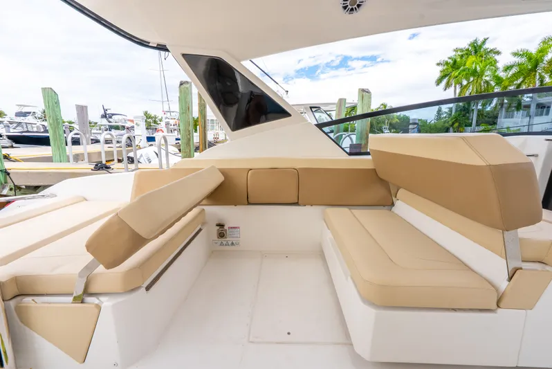 Ohana Yacht Photos Pics Luxurious seating area on a 2020 Aquila 32 yacht, docked with scenic marina views.