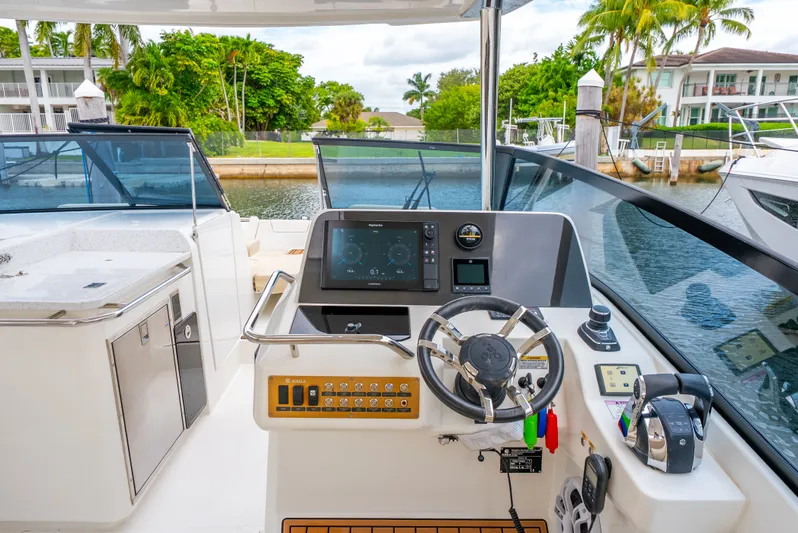 Ohana Yacht Photos Pics Helm of 2020 Aquila 32 boat with modern navigation controls and steering wheel.