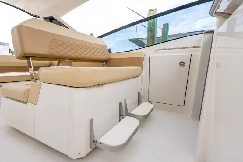 Ohana Yacht Photos Pics Interior of 2020 Aquila 32 boat with beige seating and footrests.