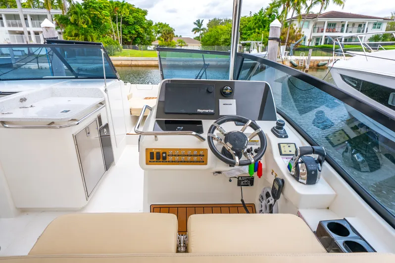 Ohana Yacht Photos Pics Helm of 2020 Aquila 32 boat with modern controls and navigation equipment.
