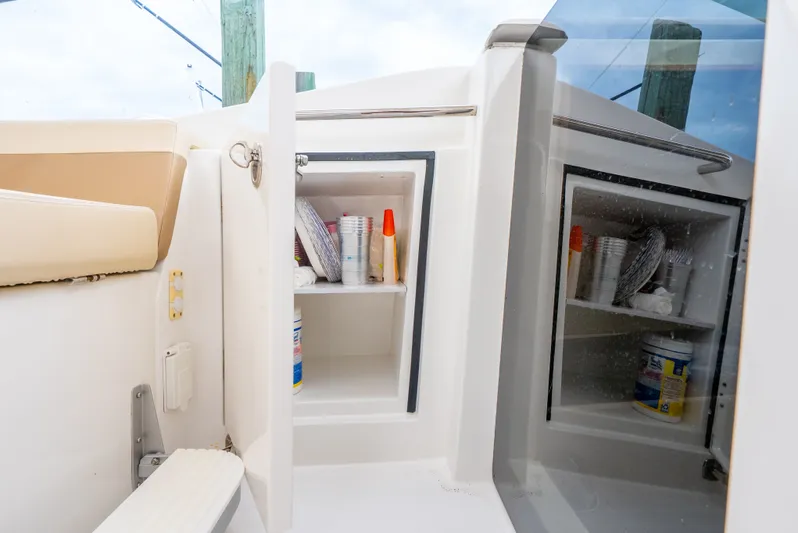 Ohana Yacht Photos Pics Storage compartment on a 2020 Aquila 32 boat, featuring shelves with supplies.