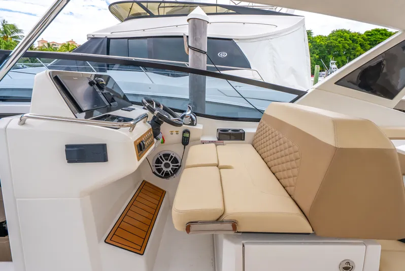 Ohana Yacht Photos Pics Interior of 2020 Aquila 32 yacht with beige seating and modern helm controls.