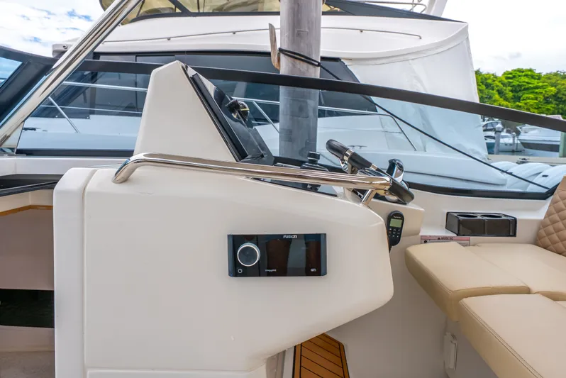 Ohana Yacht Photos Pics Helm of 2020 Aquila 32 yacht with modern controls and beige seating.