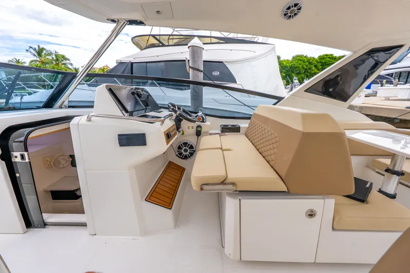 Ohana Yacht Photos Pics Interior of a 2020 Aquila 32 yacht with modern helm and seating area.