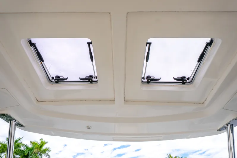 Ohana Yacht Photos Pics Rooftop hatches of 2020 Aquila 32 boat with clear sky view.