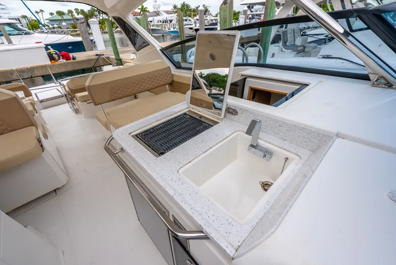 Ohana Yacht Photos Pics Luxurious 2020 Aquila 32 yacht interior with sink and seating area at marina.