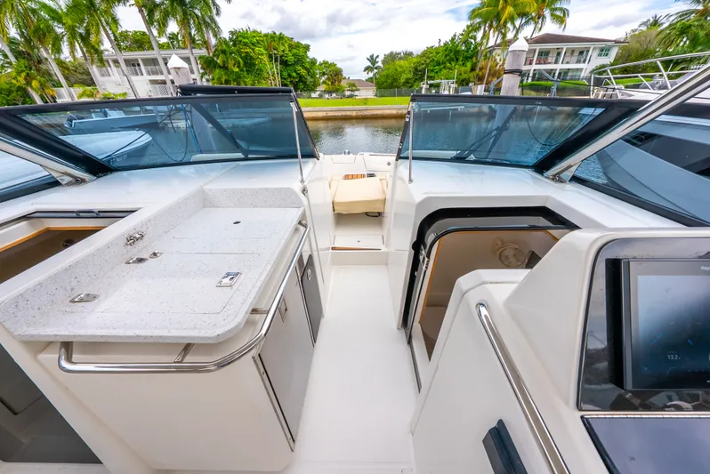 Ohana Yacht Photos Pics Aquila 32 yacht interior with sleek design, featuring a kitchenette and modern navigation system.