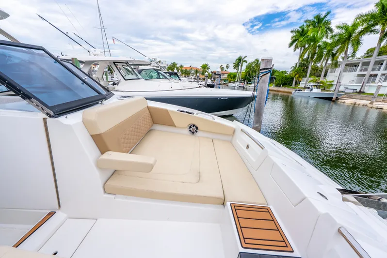 Ohana Yacht Photos Pics Luxurious 2020 Aquila 32 yacht with spacious seating, docked in a scenic marina.