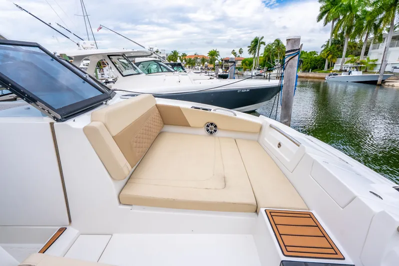 Ohana Yacht Photos Pics Luxurious seating area on a 2020 Aquila 32 yacht, docked in a scenic marina.