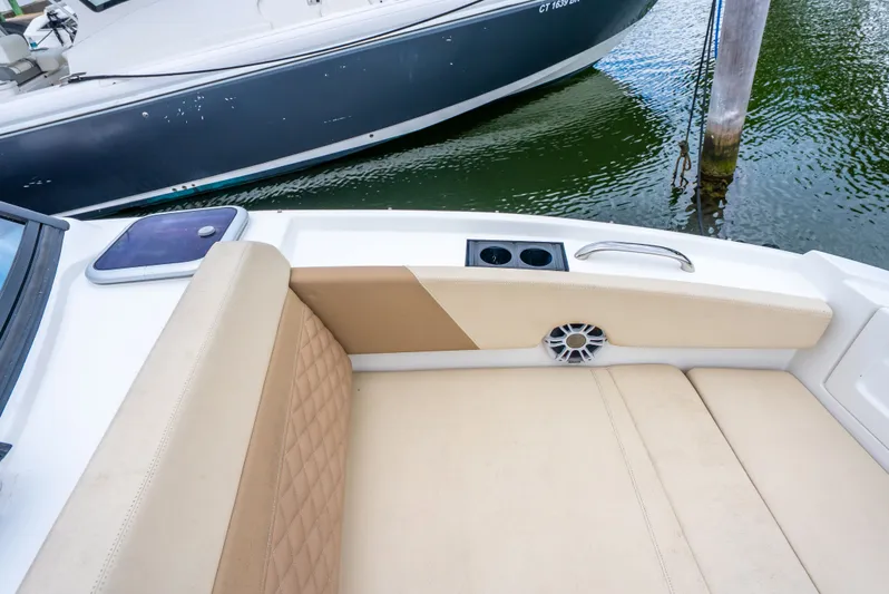 Ohana Yacht Photos Pics Aquila 32 boat interior, 2020 model, featuring beige seating and cup holders by the water.