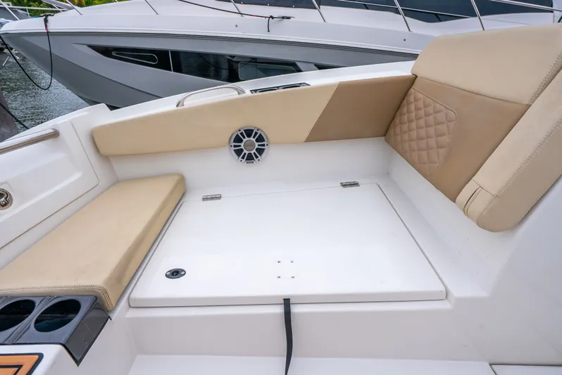 Ohana Yacht Photos Pics Aquila 32 boat interior, 2020 model, featuring beige seating and a built-in speaker.