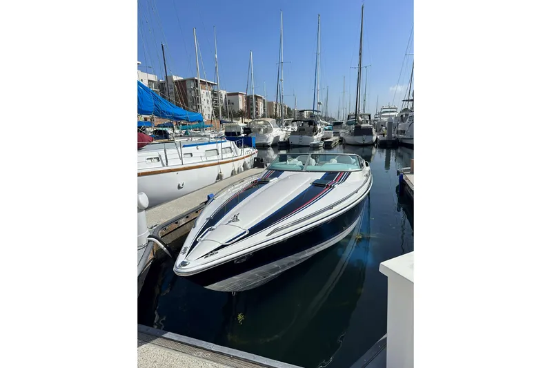  Yacht Photos Pics 2004 Formula 292 FASTech speedboat docked in a marina, surrounded by sailboats.