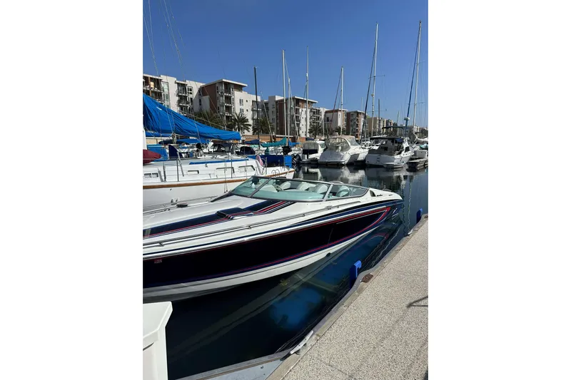  Yacht Photos Pics 2004 Formula 292 FASTech boat docked in a marina with sailboats and buildings.