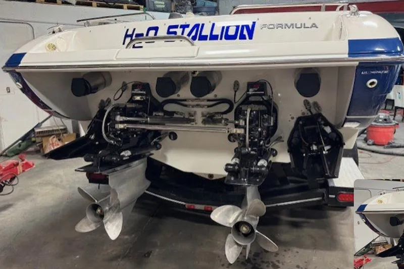  Yacht Photos Pics 2004 Formula 292 FASTech boat with dual propellers in a garage setting.