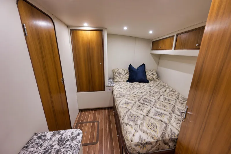 Grand Slam Yacht Photos Pics Cozy cabin interior of 2004 Guthrie 60 Custom Carolina yacht with wood accents and patterned bedding.