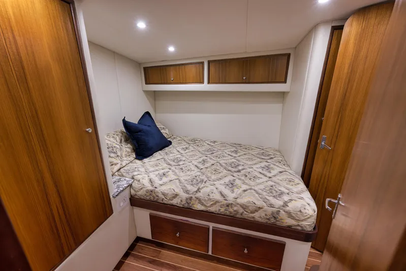 Grand Slam Yacht Photos Pics Cozy cabin interior of 2004 Guthrie 60 Custom Carolina yacht with wood accents and bedding.
