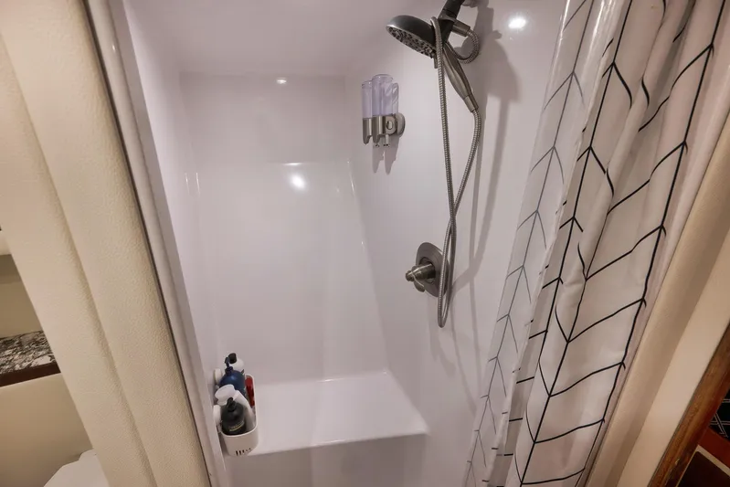 Grand Slam Yacht Photos Pics Shower area in 2004 Guthrie 60 Custom Carolina boat with modern fixtures and curtain.