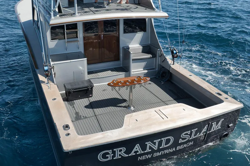 Grand Slam Yacht Photos Pics 2004 Guthrie 60 Custom Carolina yacht on ocean, featuring spacious deck and fishing equipment.