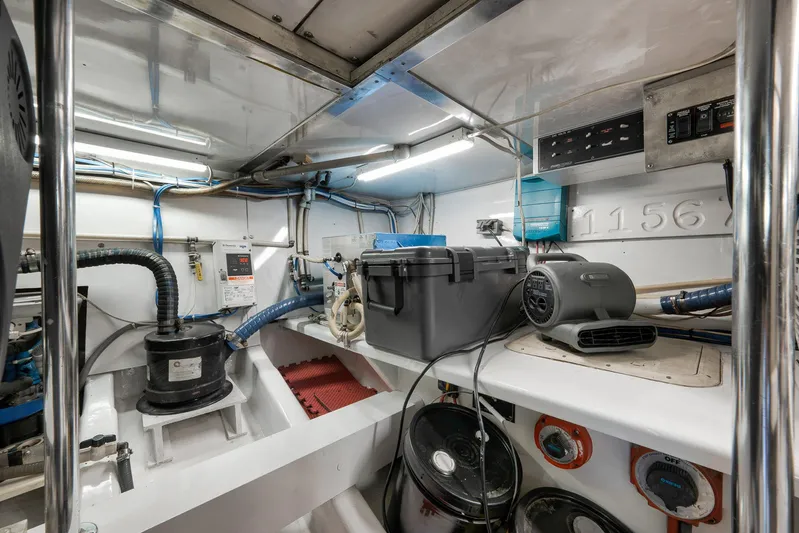 Grand Slam Yacht Photos Pics Engine room of 2004 Guthrie 60 Custom Carolina boat, featuring equipment and storage.