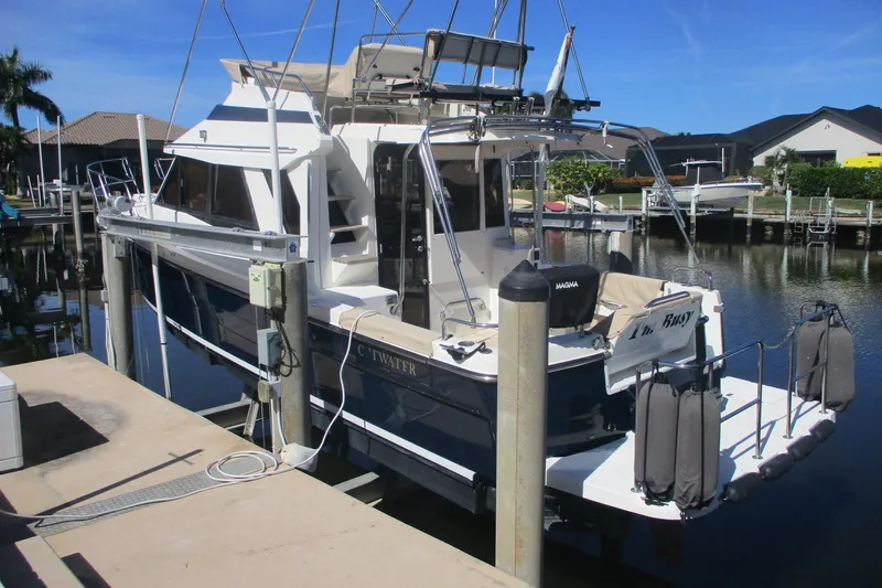 I'm Busy Yacht Photos Pics 2015 Cutwater 30 Command Bridge LE docked in a sunny marina setting.