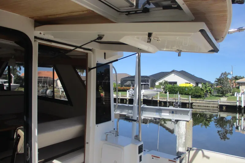 I'm Busy Yacht Photos Pics 2015 Cutwater 30 Command Bridge LE boat interior with open hatch, dockside view.